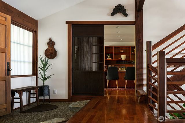 a view of entryway and hall with wooden floor