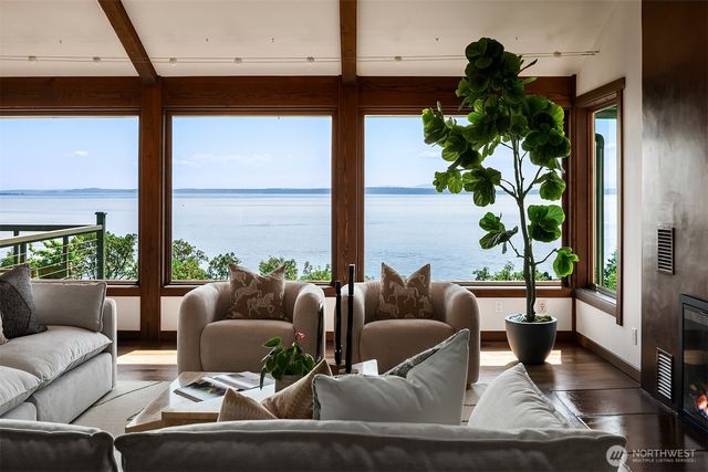 a living room with furniture and a floor to ceiling window