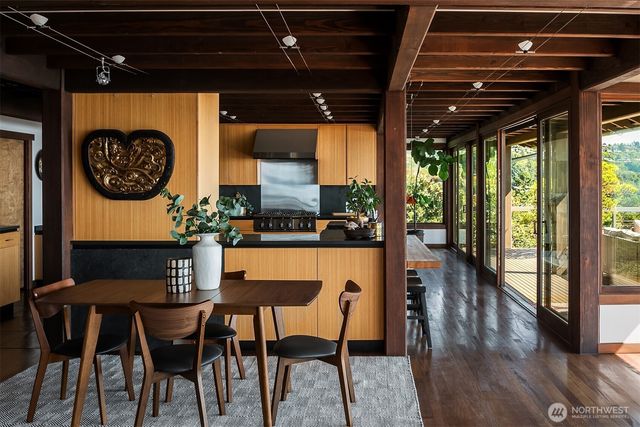 a dining room with furniture and wooden floor