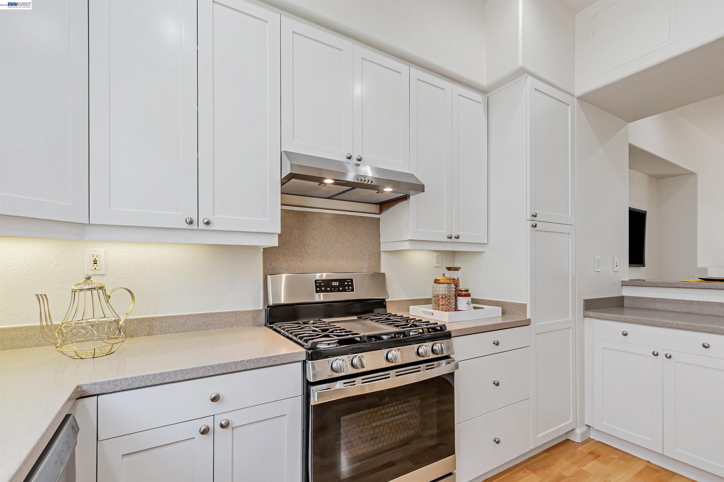39 Cloud Walk Milpitas, CA 95035 - Photo 11 of 39 a kitchen with granite countertop white cabinets and stainless steel appliances
