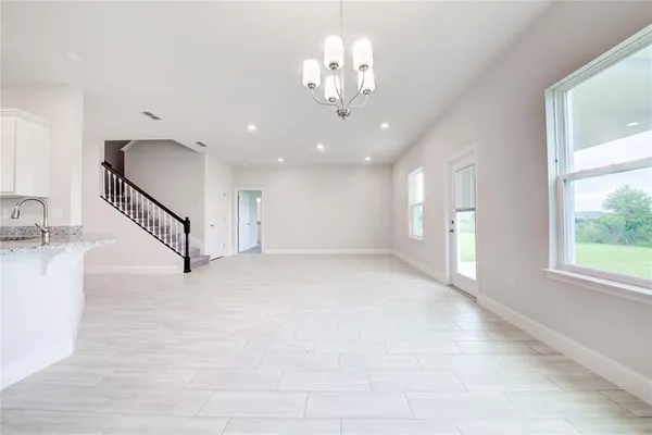 a kitchen with granite countertop a sink a stove and cabinets