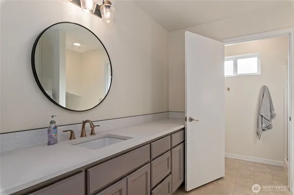 a bathroom with a sink and a mirror