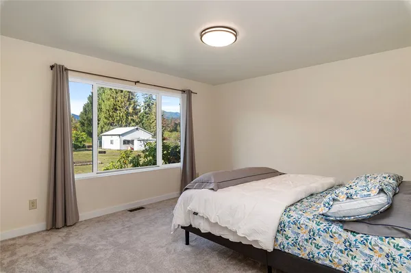 a bedroom with a bed and window
