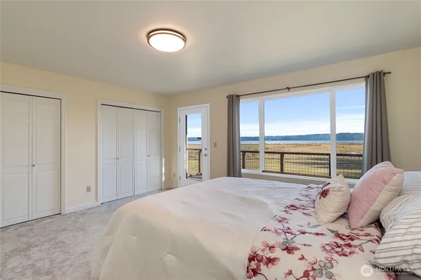 a bedroom with a large bed and a window