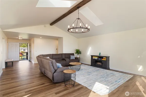 a living room with furniture and a dining table