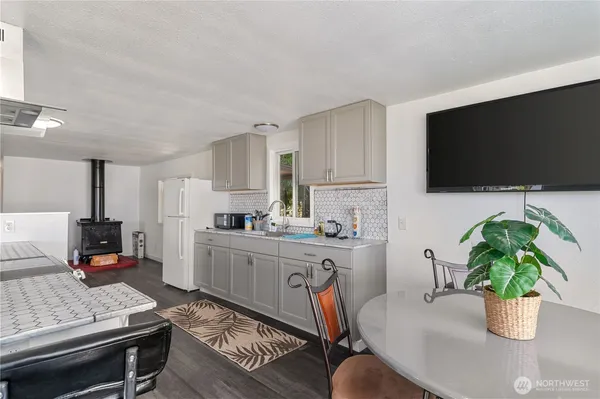a kitchen with a stove a sink and a refrigerator
