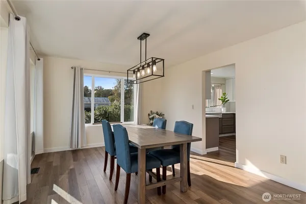 a view of a dining room with furniture window and wooden floor