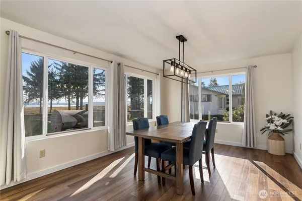 a view of a dining room with furniture window and wooden floor