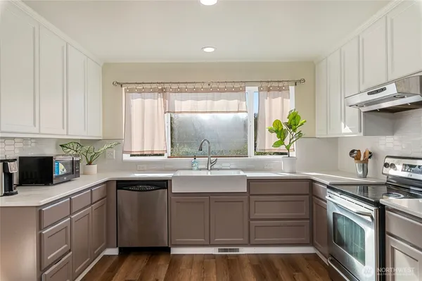 a kitchen with a sink stove and cabinets