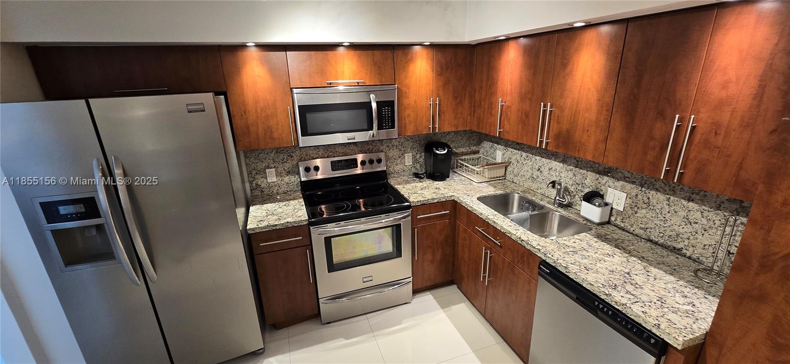 2801 Northeast 183rd Street, Unit 714W Aventura, FL 33160 - Photo 14 of 21 a kitchen with stainless steel appliances granite countertop a refrigerator a stove and a sink