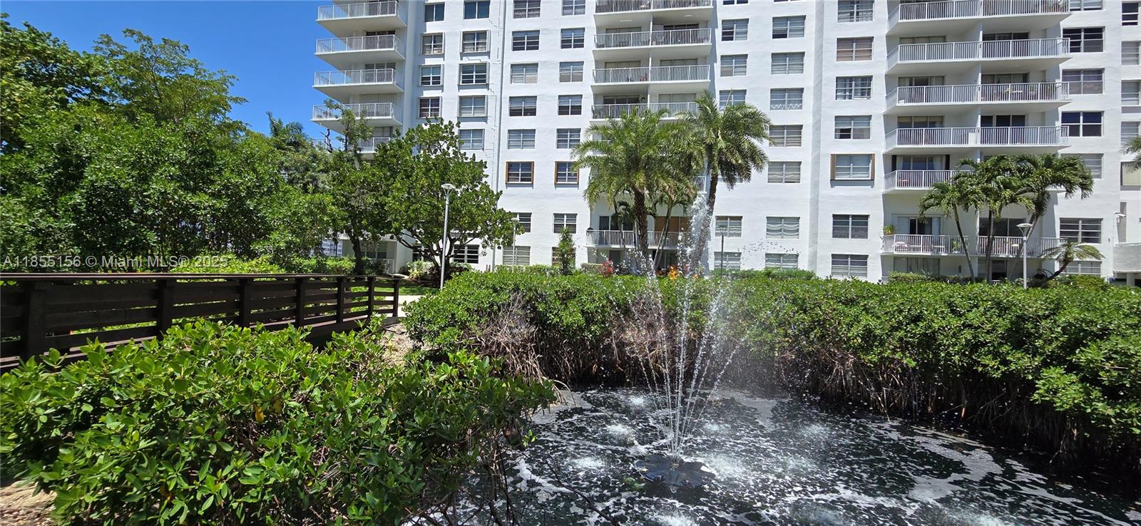 2801 Northeast 183rd Street, Unit 714W Aventura, FL 33160 - Photo 20 of 21 a view of a building with a garden