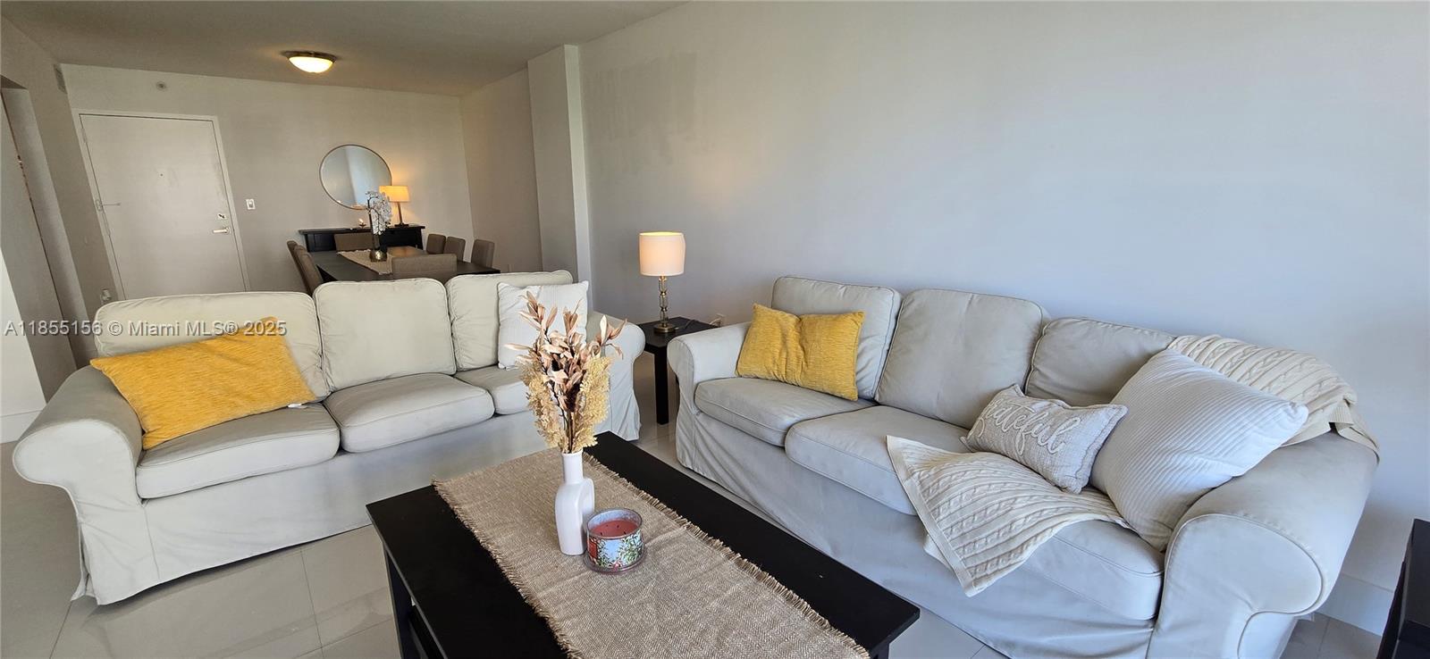 2801 Northeast 183rd Street, Unit 714W Aventura, FL 33160 - Photo 3 of 21 a living room with furniture and a couch