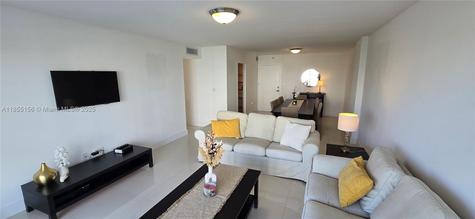 2801 Northeast 183rd Street, Unit 714W Aventura, FL 33160 - Photo 7 of 21 a living room with furniture and a flat screen tv