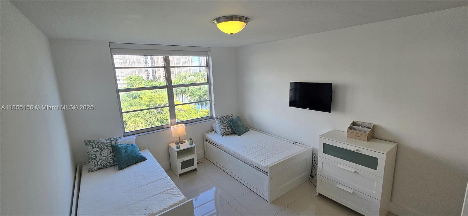 2801 Northeast 183rd Street, Unit 714W Aventura, FL 33160 - Photo 8 of 21 a living room with furniture and a flat screen tv