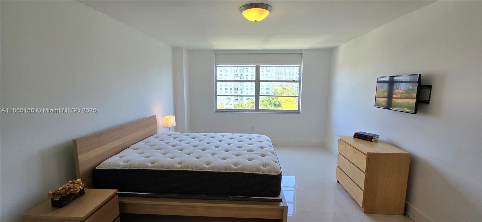 2801 Northeast 183rd Street, Unit 714W Aventura, FL 33160 - Photo 10 of 21 a bedroom with a bed and a window