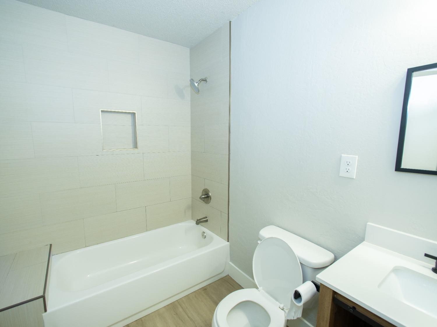 1136 East Griffith Way Fresno, CA 93704 - Photo 17 of 33 a bathroom with a sink mirror and toilet