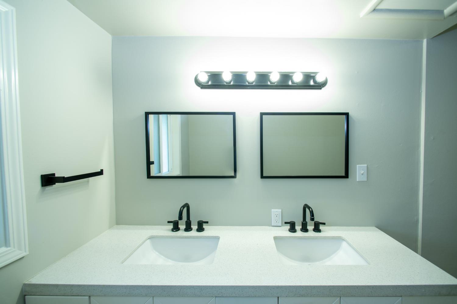 1136 East Griffith Way Fresno, CA 93704 - Photo 25 of 33 a bathroom with a sink and a mirror