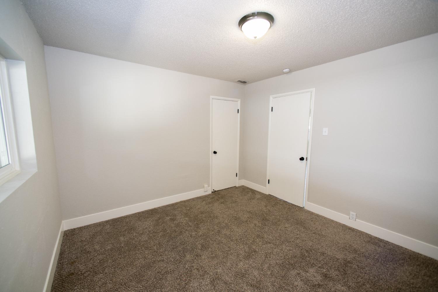 1136 East Griffith Way Fresno, CA 93704 - Photo 8 of 33 an empty room with an entryway