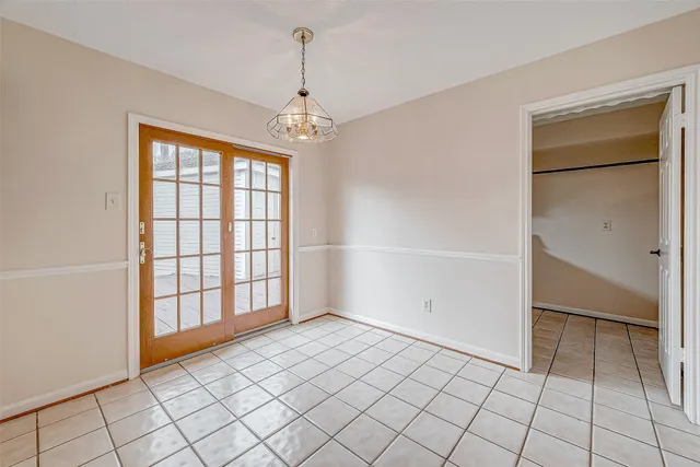 a view of a kitchen with a sink and an empty room