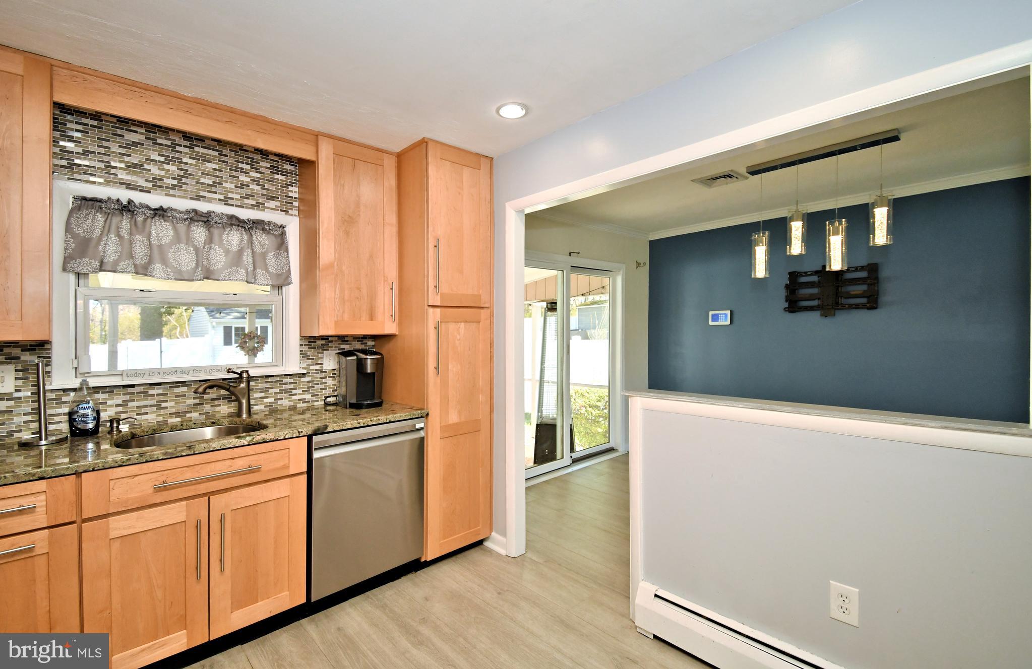 7 Sandy Drive Yardley, PA 19067 - Photo 15 of 42 a kitchen with stainless steel appliances granite countertop a refrigerator a sink and white cabinets with wooden floor