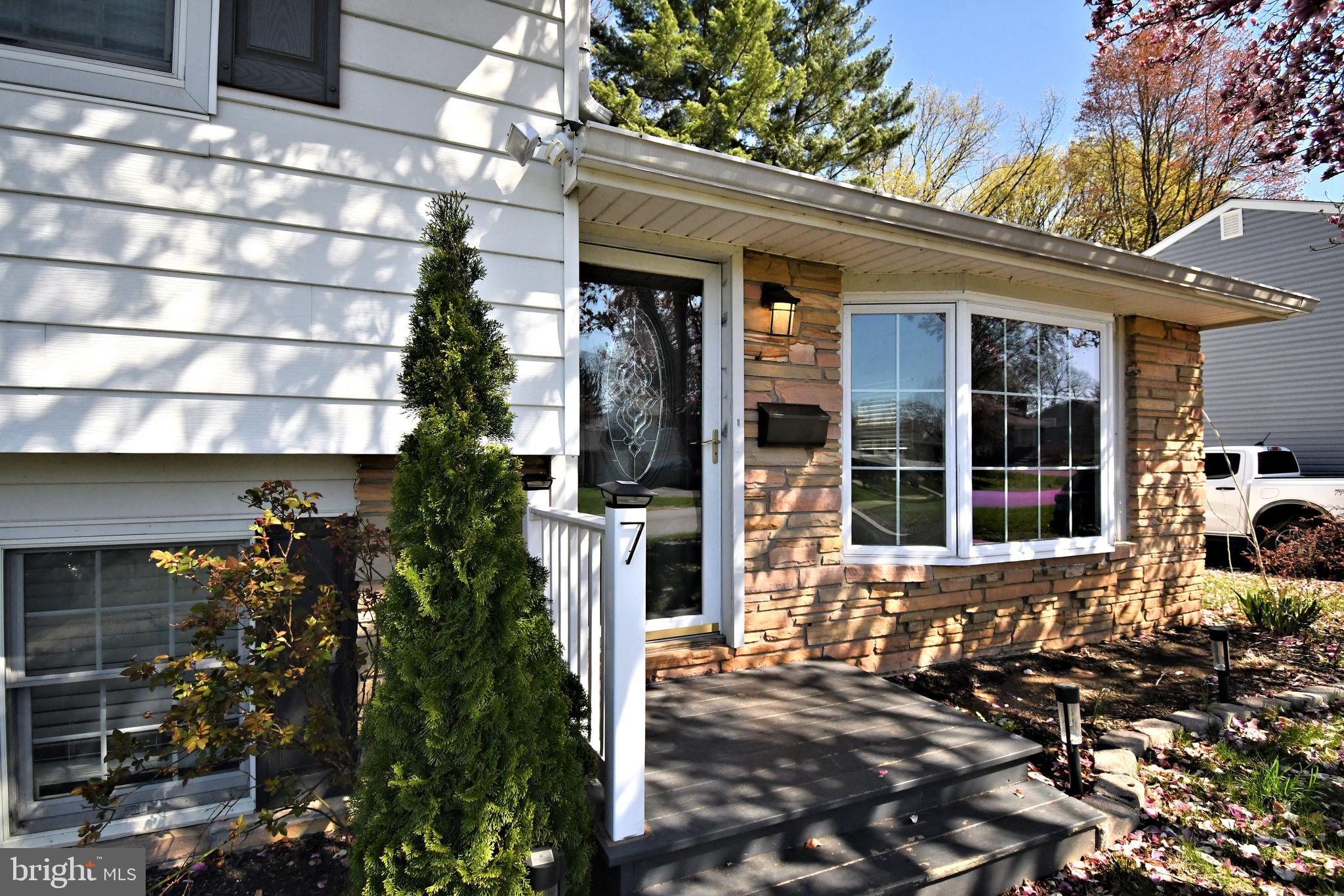 7 Sandy Drive Yardley, PA 19067 - Photo 2 of 42 a front view of a house with a porch