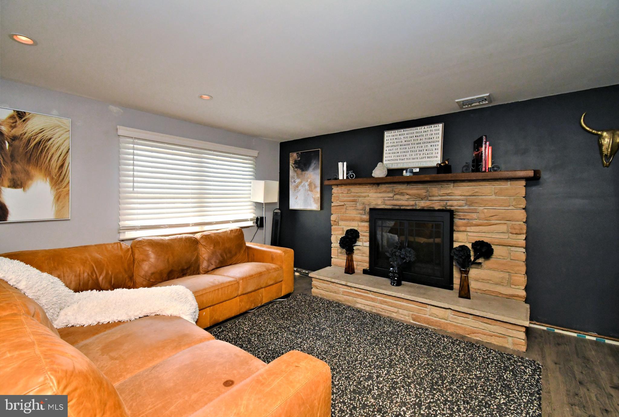 7 Sandy Drive Yardley, PA 19067 - Photo 28 of 42 a living room with furniture and a fireplace