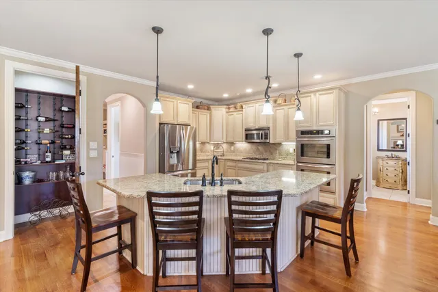 a dining room filled with furniture and wooden floor
