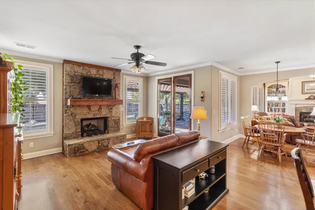 a kitchen with stainless steel appliances granite countertop a sink stove and wooden floor