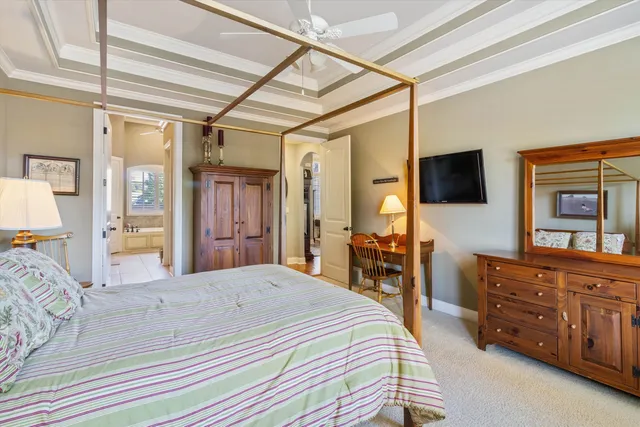 a bedroom with a bed couch and a window