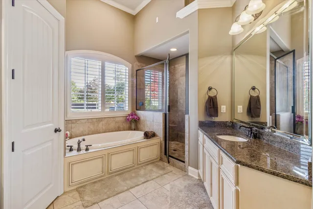 a bedroom with a bed dresser and a flat tv screen