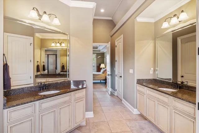a bathroom with a granite countertop tub sink and mirror