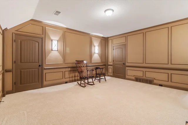 a room with gym equipment and a rug