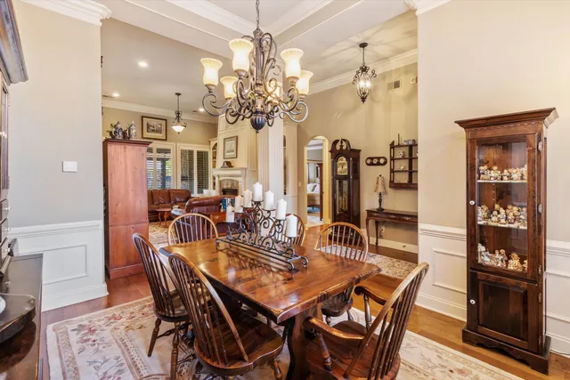 a view of a dining room with furniture wooden floor and chandelier