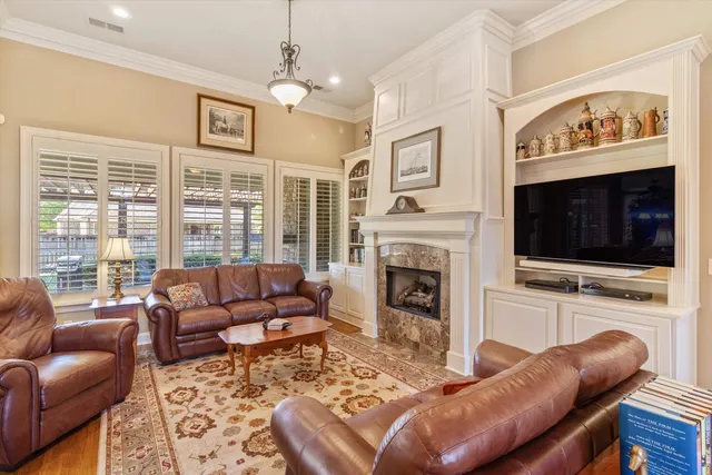 a living room with furniture a flat screen tv and a fireplace