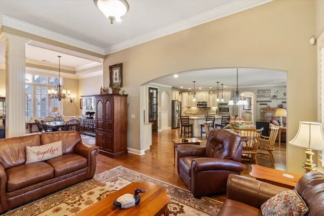 a living room with furniture and a chandelier