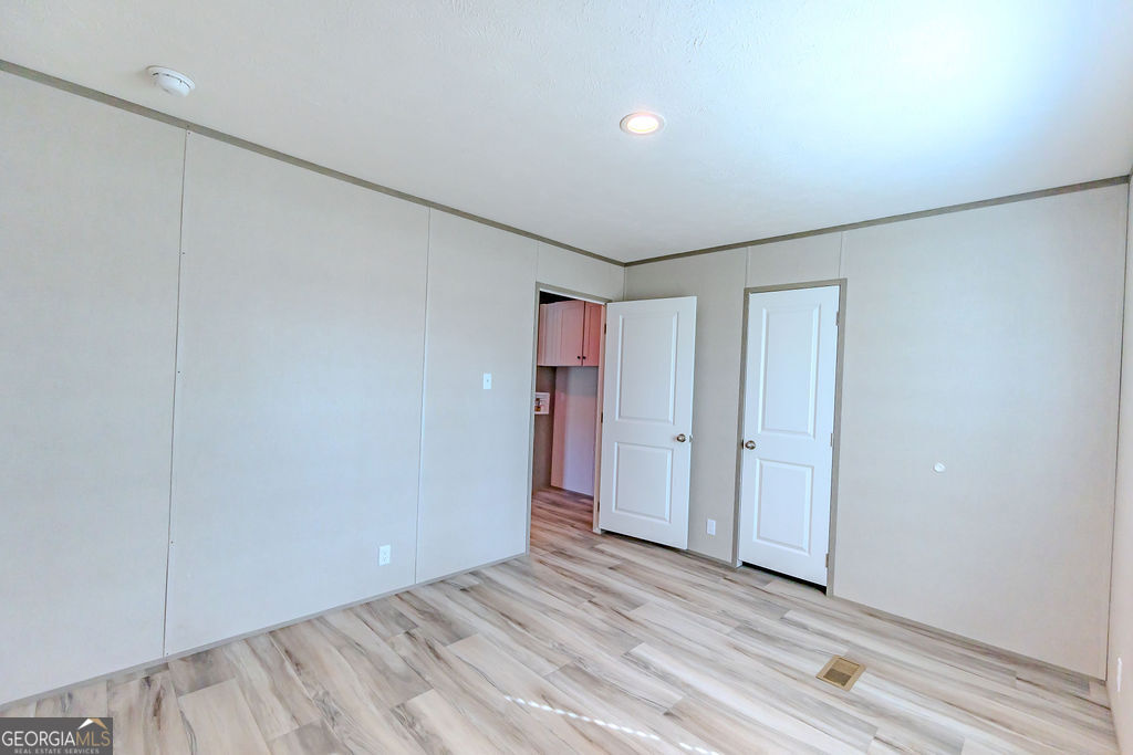 226 Mullis Street Dexter, GA 31019 - Photo 12 of 37 a view of an empty room with wooden floor