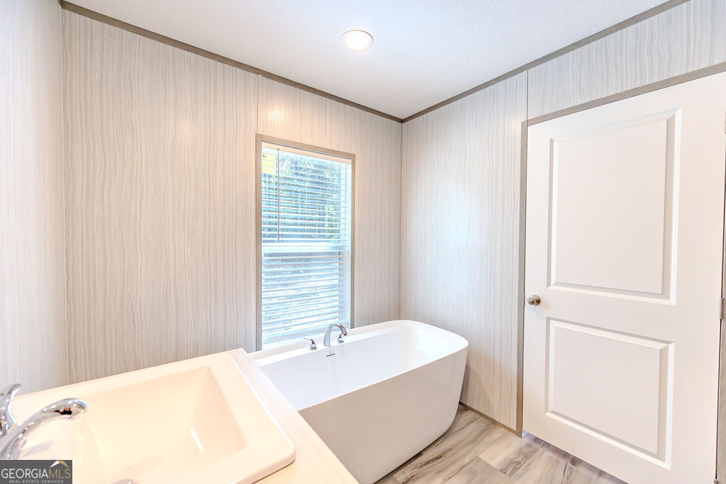 226 Mullis Street Dexter, GA 31019 - Photo 18 of 37 a spacious bathroom with a bathtub and shower