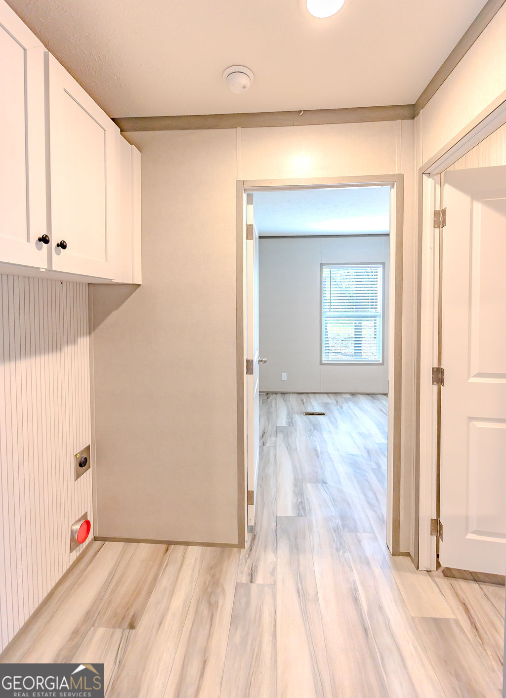 226 Mullis Street Dexter, GA 31019 - Photo 19 of 37 an empty room with wooden floor and windows