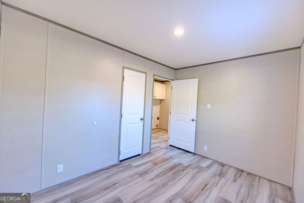 226 Mullis Street Dexter, GA 31019 - Photo 24 of 37 a view of an empty room with wooden floor