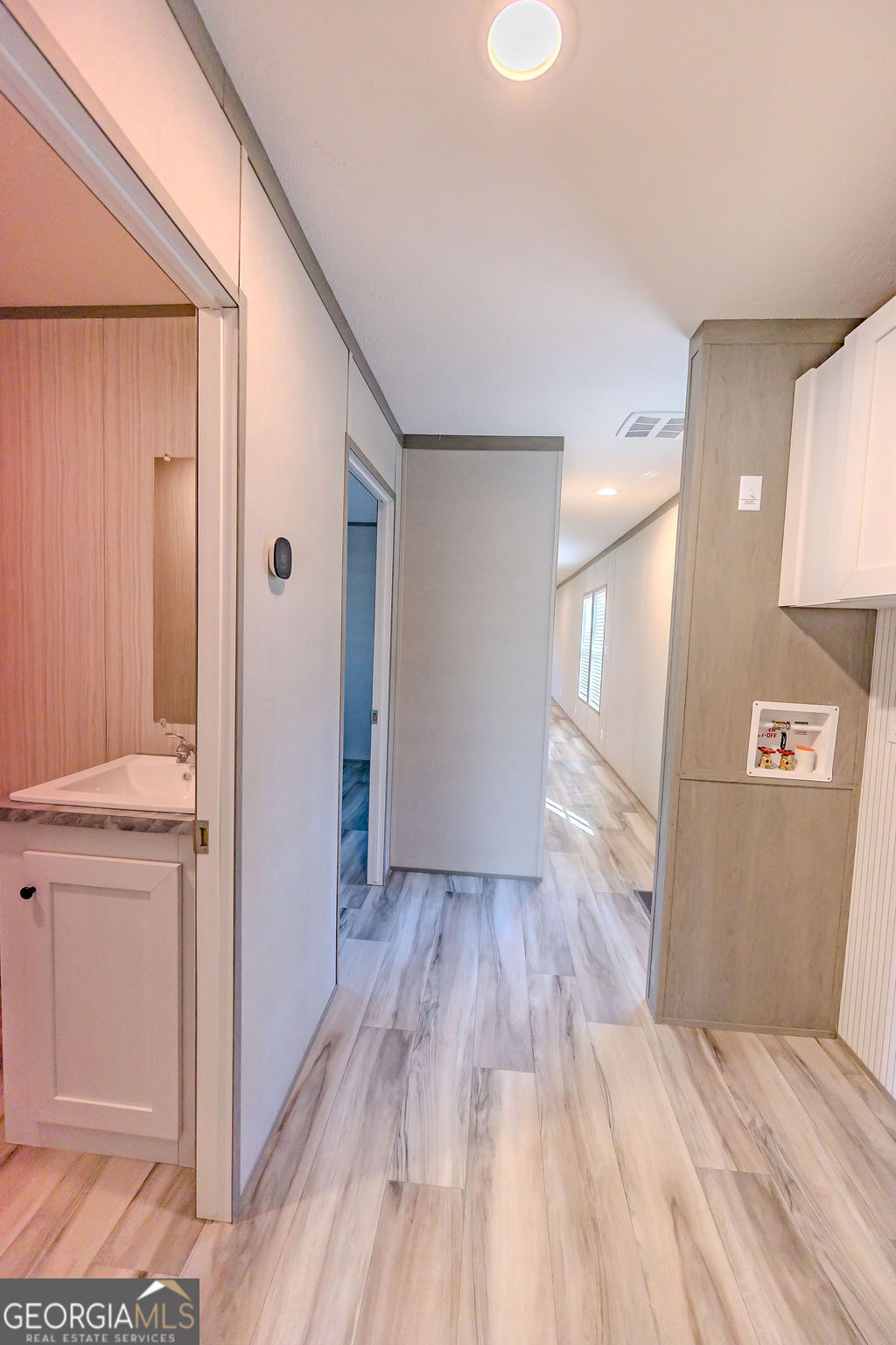 226 Mullis Street Dexter, GA 31019 - Photo 26 of 37 a view of a hallway with wooden floor and closet