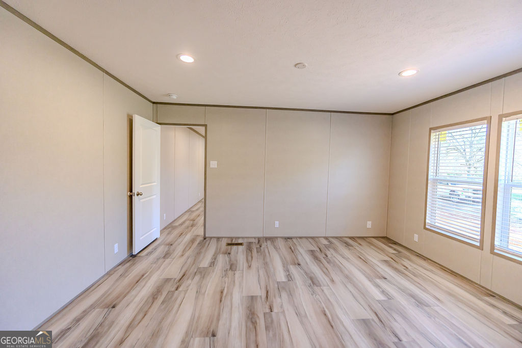 226 Mullis Street Dexter, GA 31019 - Photo 30 of 37 a view of room with window and wooden floor