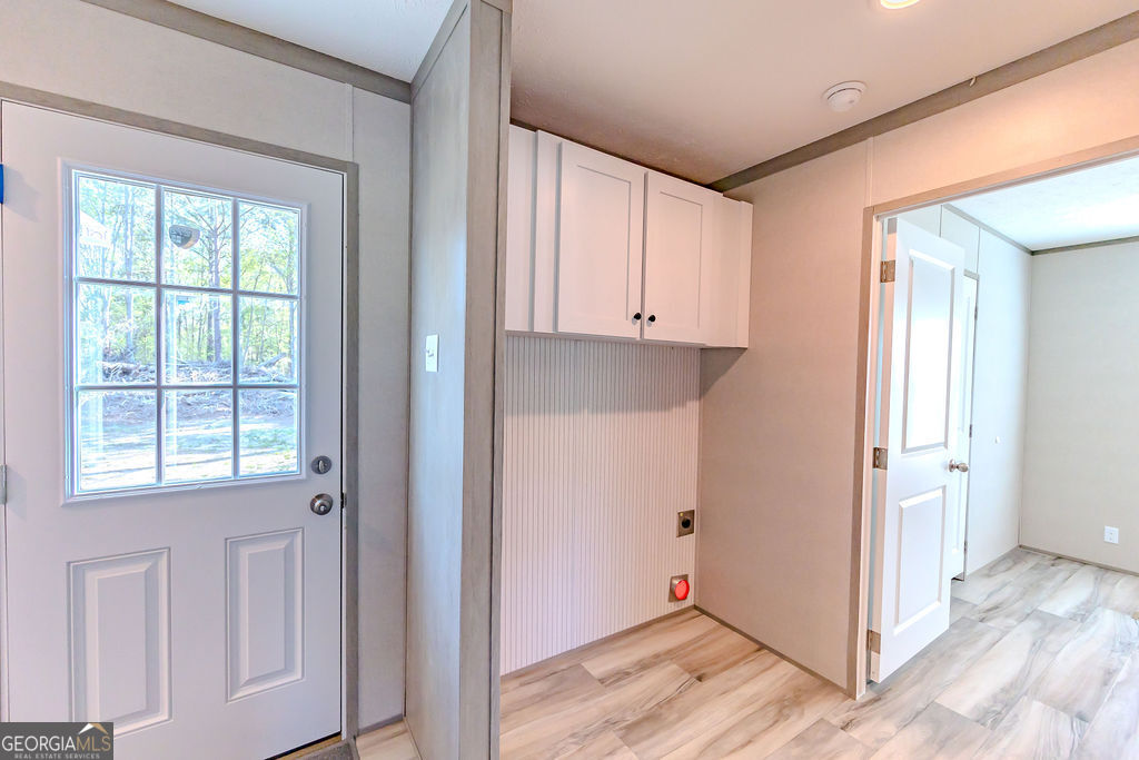 226 Mullis Street Dexter, GA 31019 - Photo 31 of 37 a view of a kitchen with wooden floor and a window