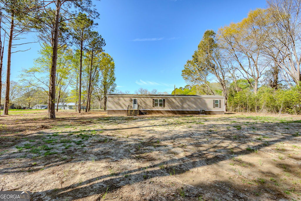 226 Mullis Street Dexter, GA 31019 - Photo 32 of 37 a view of a house with a yard