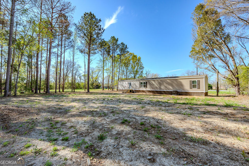 226 Mullis Street Dexter, GA 31019 - Photo 34 of 37 a view of a yard with a house