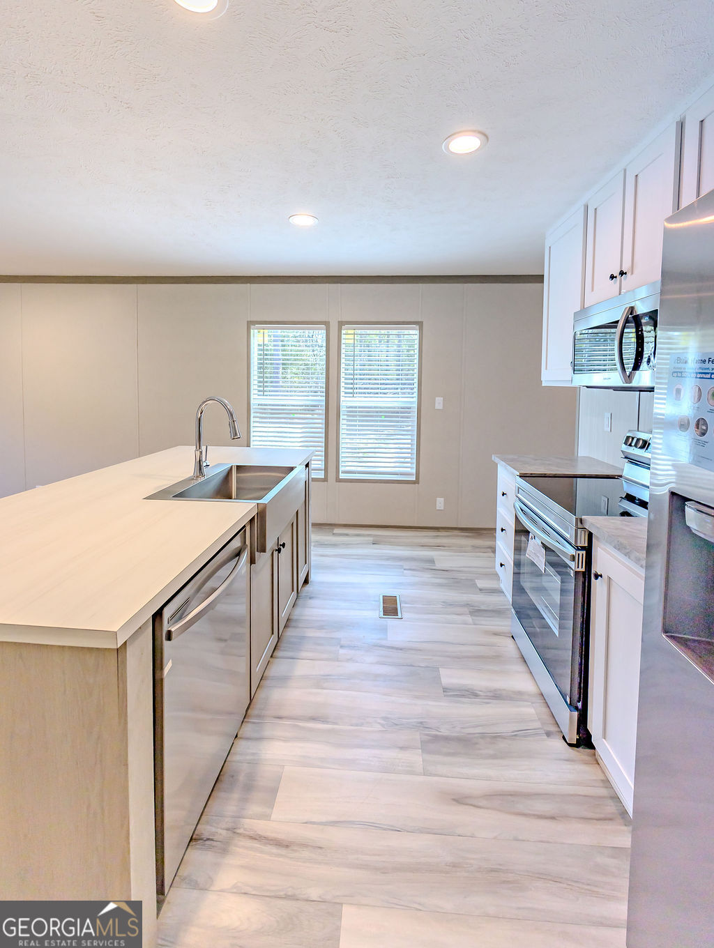 226 Mullis Street Dexter, GA 31019 - Photo 7 of 37 a kitchen with a sink and wooden cabinets