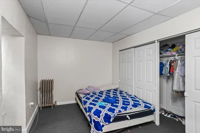 a bedroom with a bed and a walk in closet