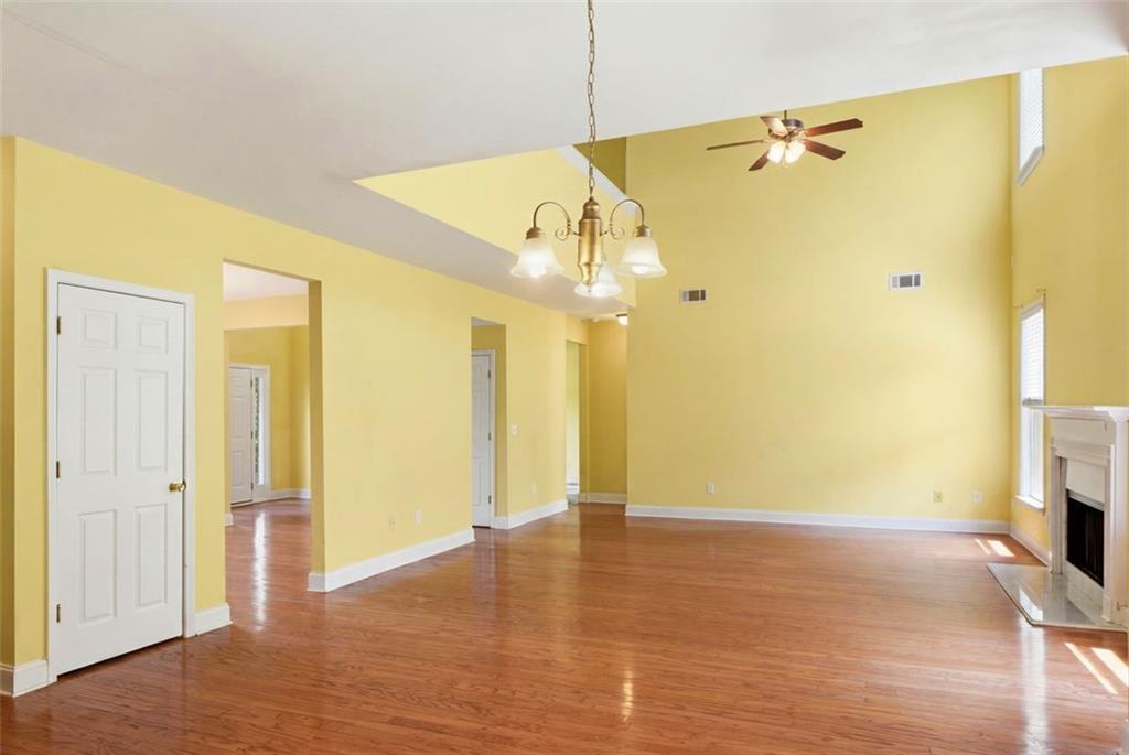 3420 Bulloch Lake Road Loganville, GA 30052 - Photo 14 of 57 a view of a big room with wooden floor and windows