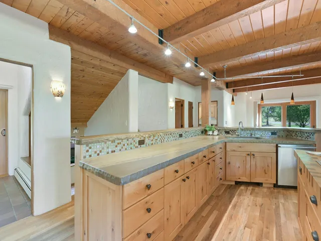 a bathroom with a granite countertop sink mirror and a bathtub