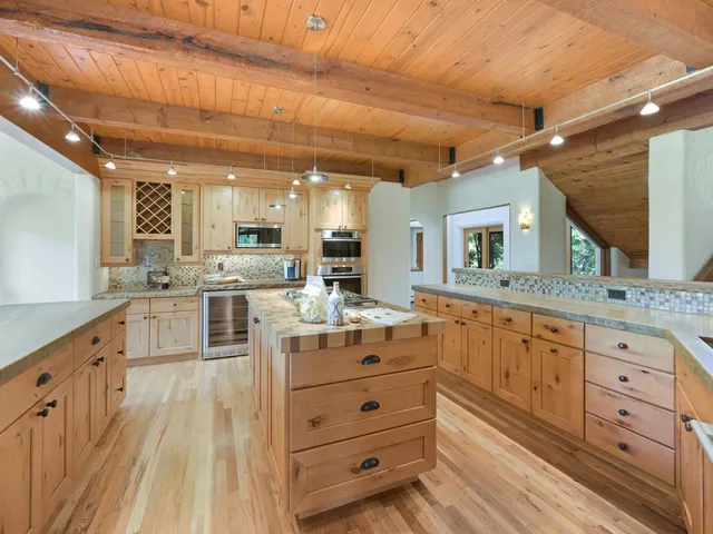 a large white kitchen with cabinets