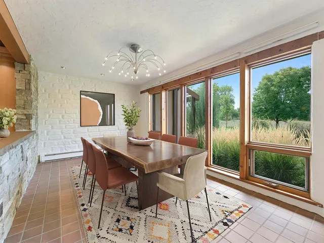 a view of a dining room with furniture large windows and wooden floor